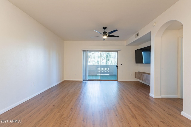 unfurnished living room with light wood-type flooring and ceiling fan