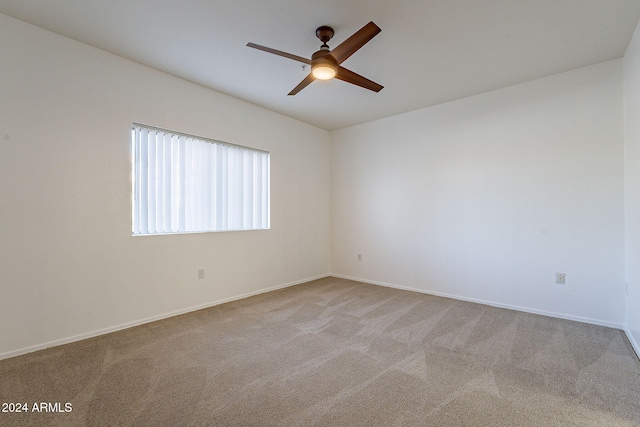 spare room with light carpet and ceiling fan