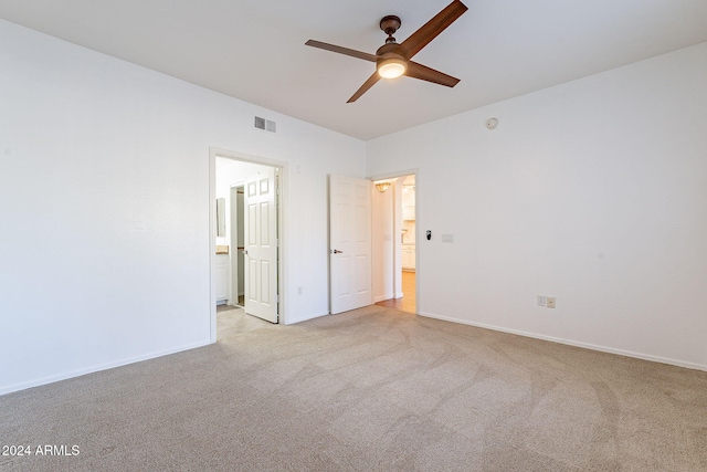 unfurnished room featuring light carpet and ceiling fan