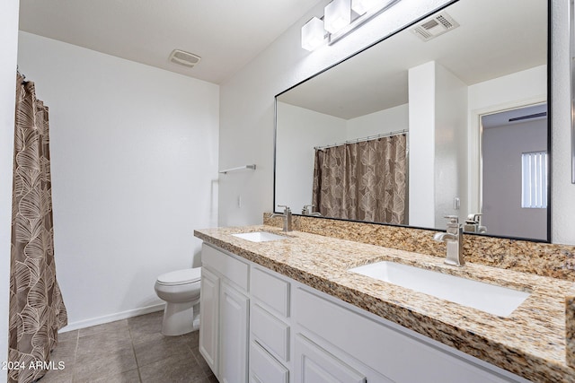 bathroom with tile patterned floors, vanity, and toilet