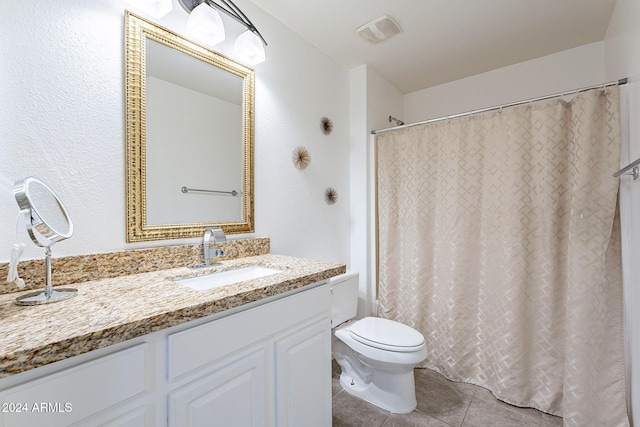 bathroom with curtained shower, tile patterned flooring, vanity, and toilet