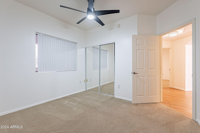 unfurnished bedroom featuring carpet flooring, a closet, and ceiling fan