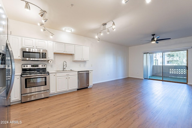 kitchen with white cabinetry, sink, ceiling fan, stainless steel appliances, and light hardwood / wood-style flooring