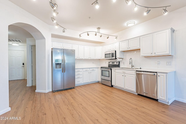 kitchen featuring white cabinets, appliances with stainless steel finishes, light hardwood / wood-style flooring, and sink