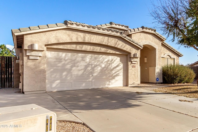 mediterranean / spanish home with a garage