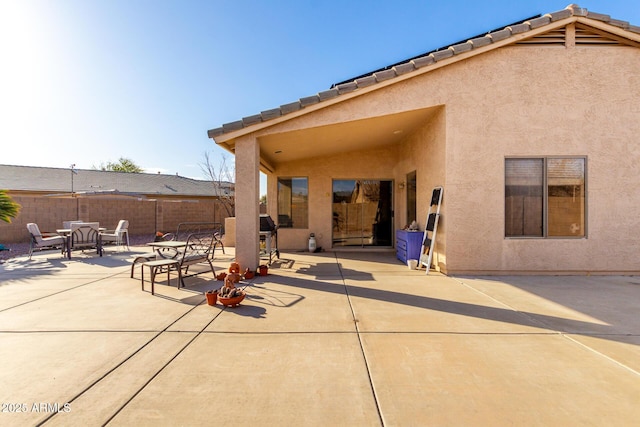 back of property with a patio