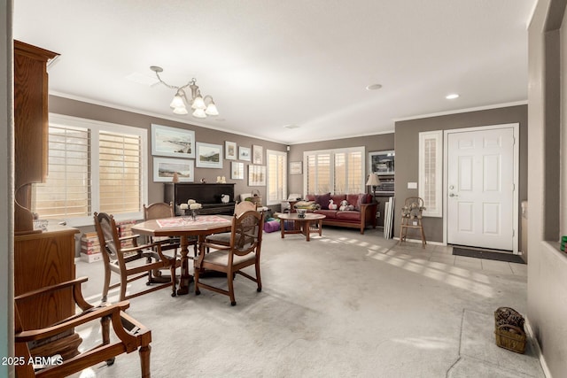 carpeted dining room with a chandelier and ornamental molding