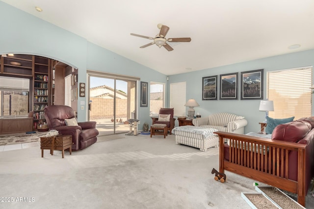 living room featuring carpet flooring, ceiling fan, and vaulted ceiling