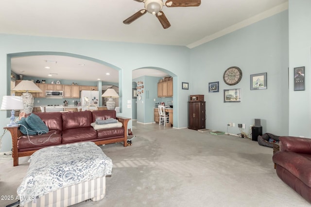 carpeted living room featuring ceiling fan