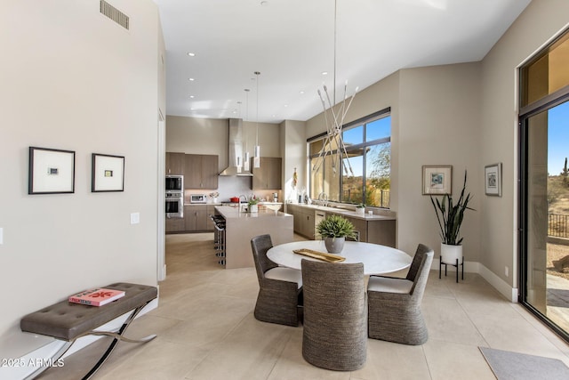 8145 E Tecolote Cir, Scottsdale, AZ 85266 - dining space featuring light tile patterned floors, recessed lighting, visible vents, a high ceiling, and baseboards