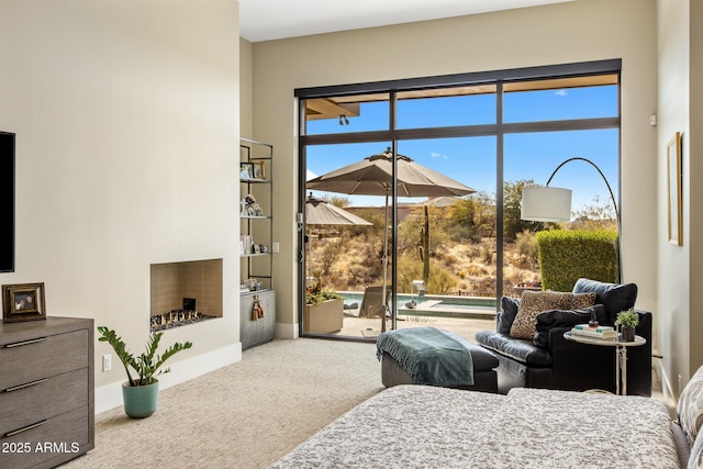 8145 E Tecolote Cir, Scottsdale, AZ 85266 - bedroom featuring access to outside, carpet flooring, a lit fireplace, and baseboards
