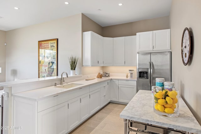 8145 E Tecolote Cir, Scottsdale, AZ 85266 - kitchen with stainless steel refrigerator with ice dispenser, recessed lighting, white cabinetry, a sink, and a peninsula