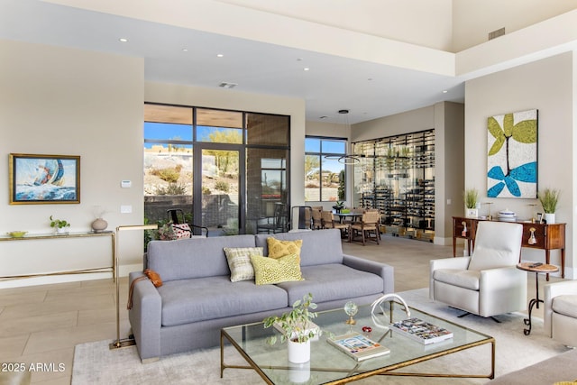 8145 E Tecolote Cir, Scottsdale, AZ 85266 - living area with recessed lighting, visible vents, a towering ceiling, and light tile patterned floors