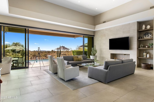 8145 E Tecolote Cir, Scottsdale, AZ 85266 - living room with a fireplace, light tile patterned flooring, and built in features