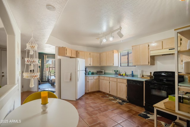 kitchen with black appliances, light brown cabinets, a sink, and a textured ceiling