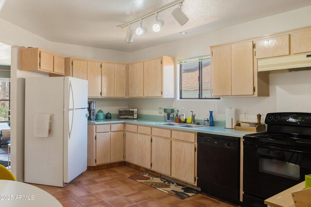 kitchen featuring under cabinet range hood, black appliances, and light brown cabinetry