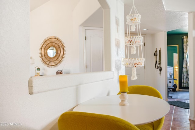 dining space with arched walkways and a notable chandelier