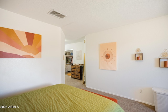 carpeted bedroom with visible vents and baseboards