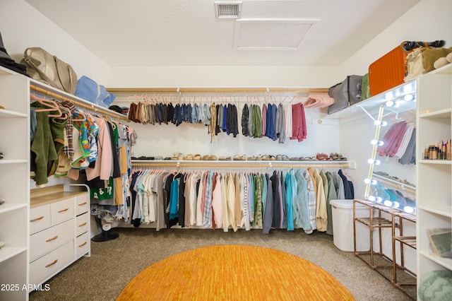 spacious closet with attic access, visible vents, and carpet floors