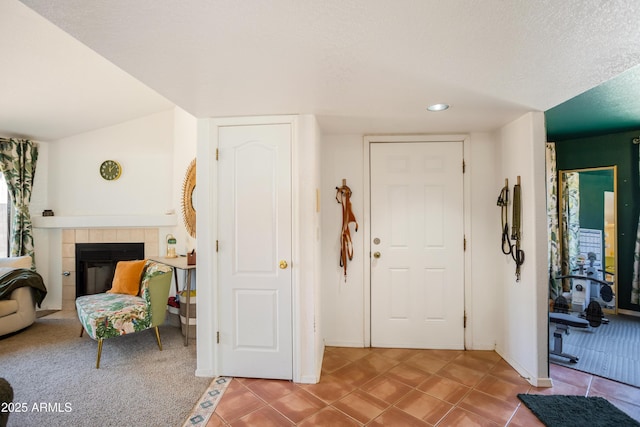tiled entrance foyer with a tiled fireplace and baseboards