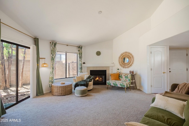 living area featuring a fireplace, lofted ceiling, and carpet floors