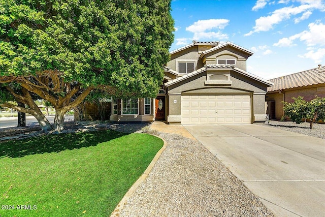 view of front facade with a front yard and a garage