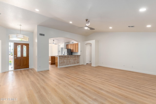 unfurnished living room with ceiling fan, light hardwood / wood-style floors, and lofted ceiling