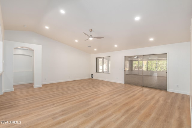 spare room with ceiling fan, vaulted ceiling, and light hardwood / wood-style flooring