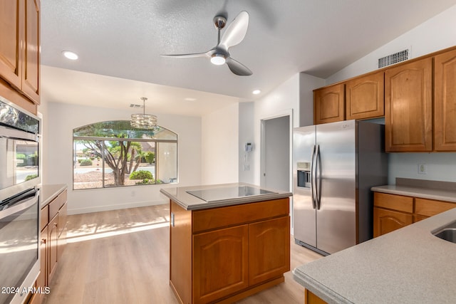 kitchen with stainless steel fridge with ice dispenser, decorative light fixtures, vaulted ceiling, a kitchen island, and light wood-type flooring