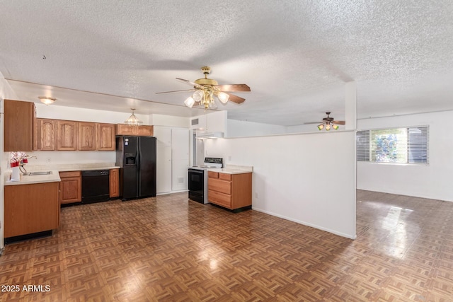 kitchen featuring dark parquet flooring, ceiling fan, black appliances, and a textured ceiling