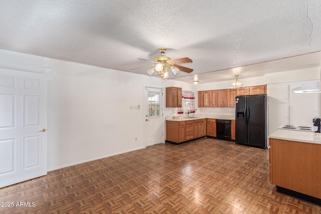 kitchen featuring black appliances, dark parquet floors, sink, ceiling fan, and a textured ceiling