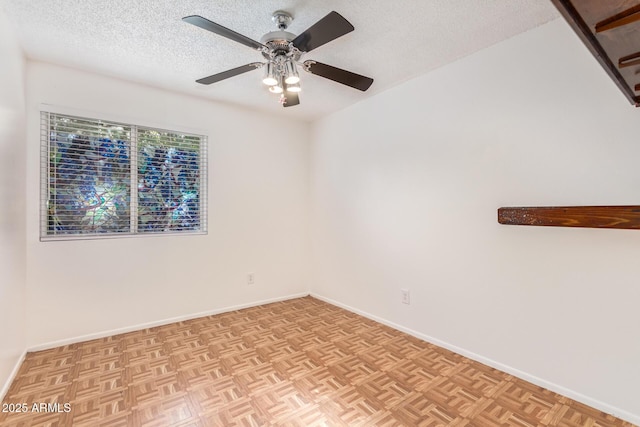 unfurnished room featuring ceiling fan, a textured ceiling, and light parquet flooring