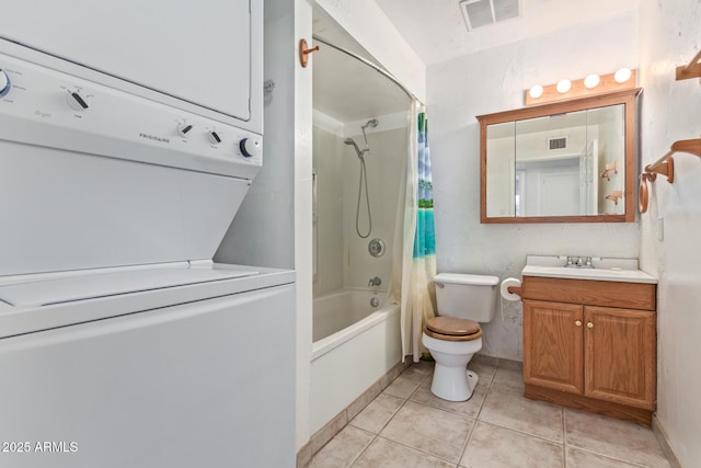 full bathroom with tile patterned floors, vanity, shower / tub combo with curtain, stacked washer and clothes dryer, and toilet