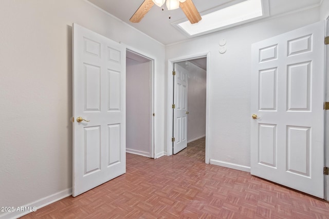 unfurnished bedroom with light parquet flooring and ceiling fan