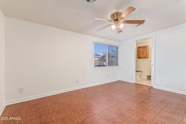 spare room with ceiling fan and light parquet floors