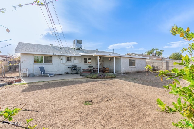 back of property featuring cooling unit and a patio area