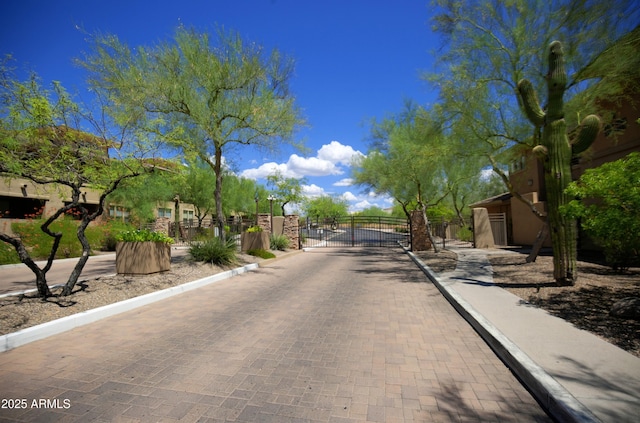 20100 N 78th Pl Unit 2105, Scottsdale, AZ 85255 - view of road featuring a gate, a gated entry, and curbs