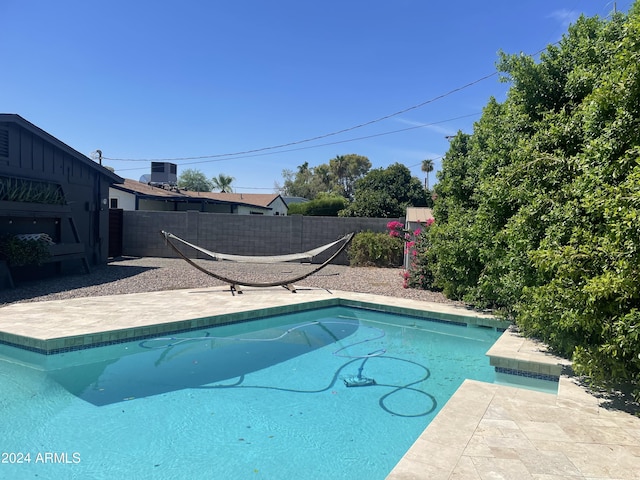 view of pool featuring a patio area and central AC