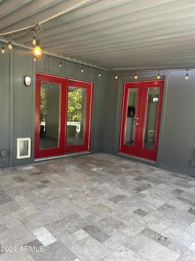 view of exterior entry featuring a patio area and french doors