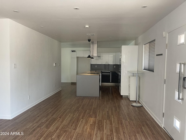 kitchen featuring dark wood-type flooring, island range hood, white cabinets, and a center island