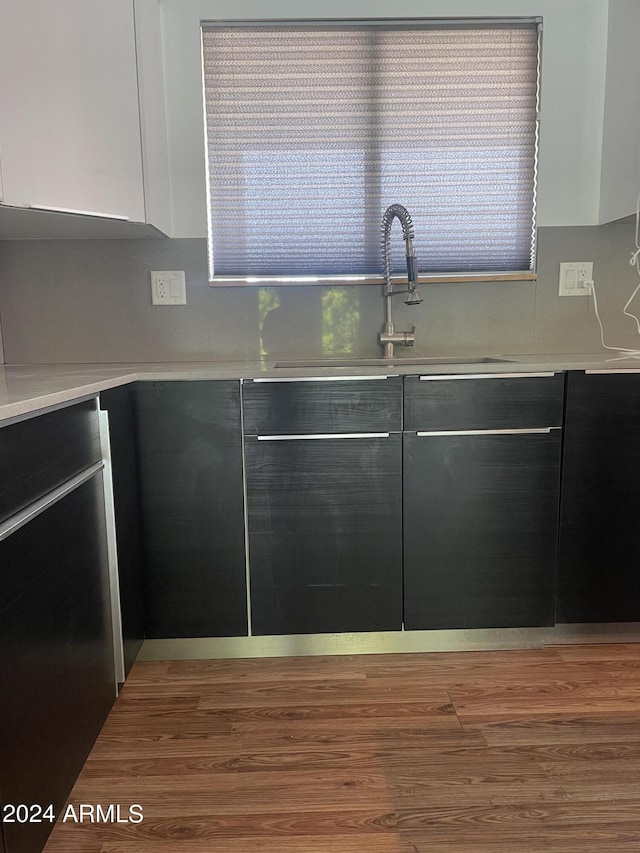 kitchen featuring white cabinetry, dishwasher, and sink