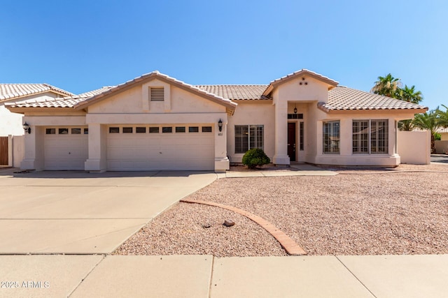 871 W Mesquite St, Gilbert, AZ 85233 - mediterranean / spanish house featuring a garage, stucco siding, concrete driveway, and a tile roof
