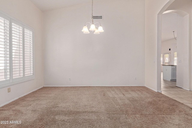 871 W Mesquite St, Gilbert, AZ 85233 - spare room featuring light carpet, arched walkways, and a chandelier