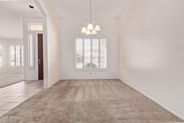 871 W Mesquite St, Gilbert, AZ 85233 - unfurnished room featuring light carpet, healthy amount of natural light, a chandelier, and light tile patterned floors