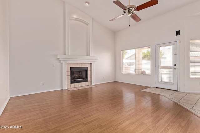 871 W Mesquite St, Gilbert, AZ 85233 - unfurnished living room featuring wood finished floors, ceiling fan, a fireplace, and high vaulted ceiling