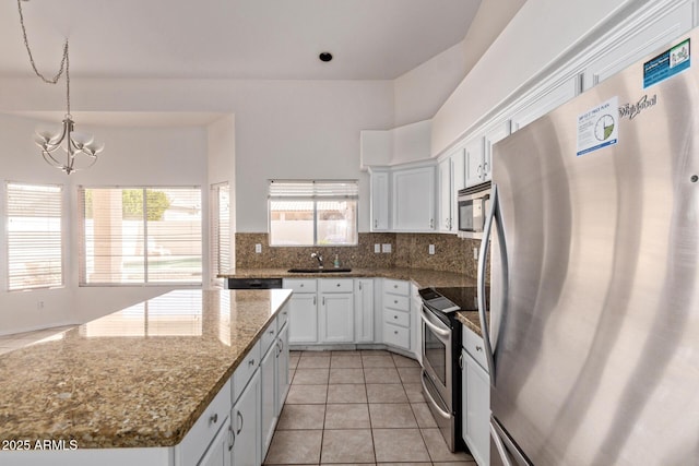 871 W Mesquite St, Gilbert, AZ 85233 - kitchen featuring appliances with stainless steel finishes, a chandelier, decorative backsplash, and white cabinets