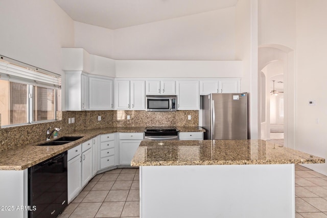 871 W Mesquite St, Gilbert, AZ 85233 - kitchen with stainless steel appliances, light tile patterned flooring, white cabinets, decorative backsplash, and high vaulted ceiling