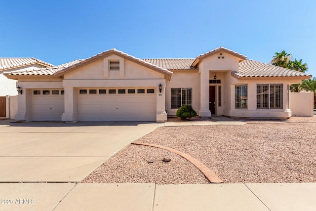 871 W Mesquite St, Gilbert, AZ 85233 - mediterranean / spanish-style house featuring stucco siding, a garage, driveway, and a tile roof