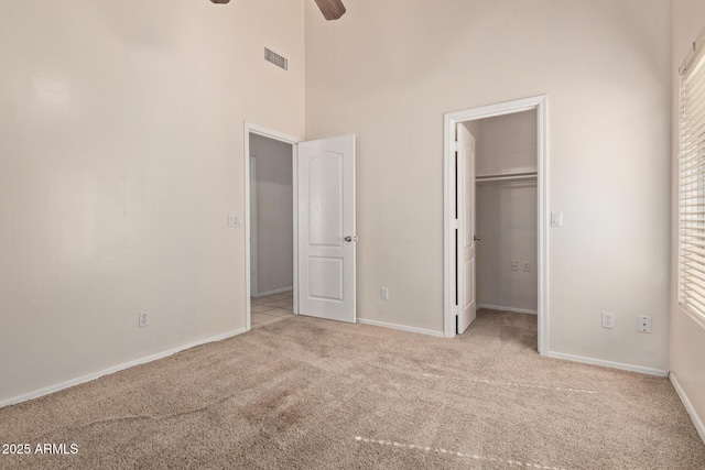 871 W Mesquite St, Gilbert, AZ 85233 - unfurnished bedroom featuring carpet, a towering ceiling, a spacious closet, and a ceiling fan