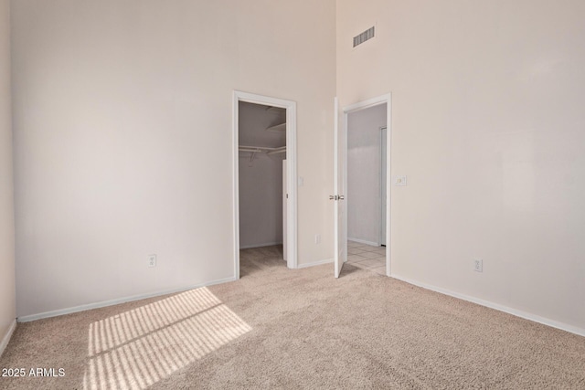 871 W Mesquite St, Gilbert, AZ 85233 - unfurnished bedroom with light colored carpet, a high ceiling, a spacious closet, and a closet